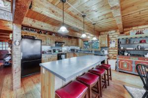 a kitchen with a large island with bar stools at Log Cabin with a View in Andover