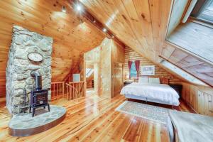 a bedroom with a fireplace in a log cabin at Log Cabin with a View in Andover