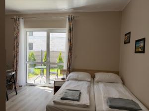 a bedroom with a bed and a large window at Villa Rowena in Rowy