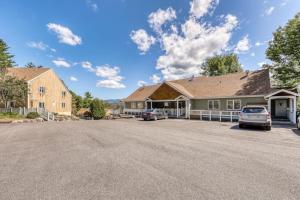 a house with two cars parked in the street at Mountainside Resort H203 in Stowe