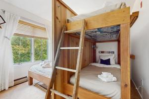 a bedroom with two bunk beds and a window at 17A Mountain Village #241 in Dover +43 photos