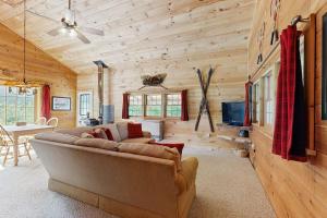 a living room with a couch and a tv at Wandering Trails Retreat in Cambridge