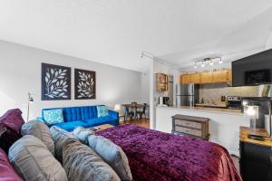 a living room with a blue couch and a kitchen at Blazing Saddles #102 in Breckenridge