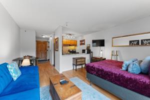 a living room with a bed and a kitchen at Blazing Saddles #102 in Breckenridge