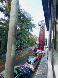 a street with cars parked in front of a building at Hospedaje ALETHIA in Huacho
