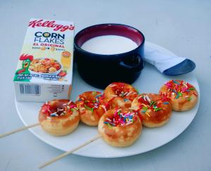 a plate of donuts and a box of cereal and a cup of milk at Hotel Victoria Atitlan in San Pedro La Laguna