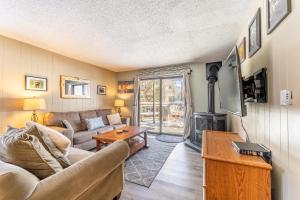 a living room with a couch and a tv at Key Condo #2929 in Keystone