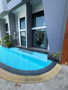 a large swimming pool in the middle of a building at Utopia Loft in Rawai Beach +10 photos