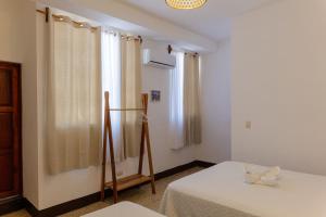 a room with two beds and a window at Casa Ramona in Flores