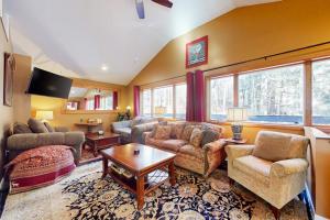 a large living room with couches and a table at The Nest in Irasville