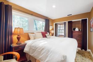 a bedroom with a large white bed and a window at The Nest in Irasville