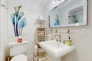 a bathroom with a sink and a toilet and a mirror at Mill Run 10E in Quechee +49 photos