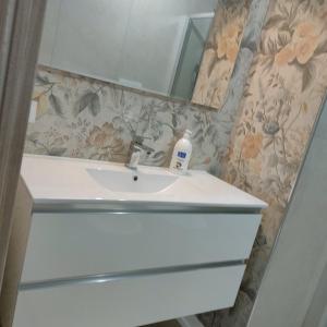 a bathroom with a sink and a mirror at ANAMI' Suite Apartament in Bovalino Marina