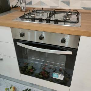 a stove top oven sitting in a kitchen at ANAMI' Suite Apartament in Bovalino Marina