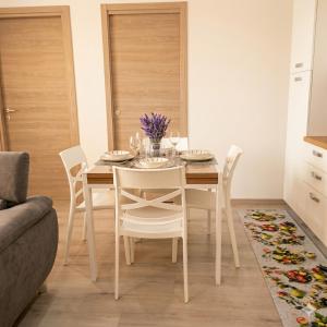 a dining room with a white table and chairs at ANAMI' Suite Apartament in Bovalino Marina +9 photos
