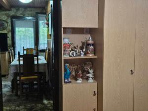 a room with a shelf with figurines on it at Villa Vishensburg in Višni