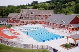 an aerial view of a large swimming pool in front of a building at Kingswood 6E in Quechee