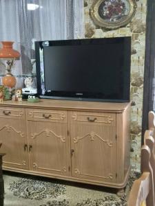 a large television on top of a wooden cabinet at Villa Vishensburg in Višni