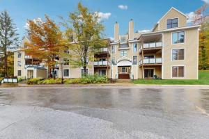 a large apartment building with a parking lot at The Seasons G17 in West Dover