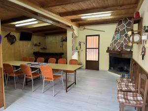 a dining room with a table and chairs and a fireplace at Casa Bartolo in Vélez-Rubio