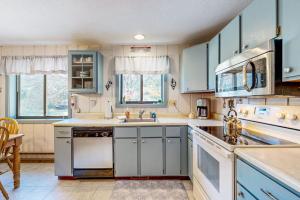 a kitchen with blue cabinets and white appliances at Dover Green 15F in Dover