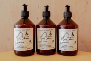 a group of three bottles of sauce on a table at Tiny House - Nature&calme - Pétanque&barbecue in Quincey