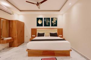 a bedroom with a large bed in a room at Hotel O Kamala Resort in Bhubaneshwar