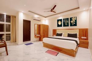 a bedroom with a large bed in a room at Hotel O Kamala Resort in Bhubaneshwar +46 photos