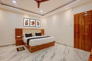 a bedroom with a large bed in a room at Hotel O Kamala Resort in Bhubaneshwar
