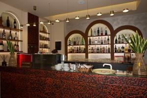 a bar with a counter with bottles of alcohol at Hotel Frida in Himare