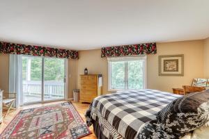 a bedroom with a bed and two windows at Paradise in Vermont in Warren