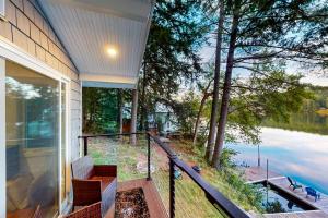 a balcony of a house with a view of the water at Bon Vie Chalet in Ludlow