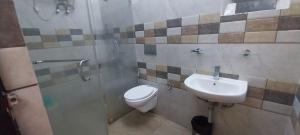a bathroom with a toilet and a sink at Townhouse Mylliem Formerly Infinity Bed & Breakfast in Shillong