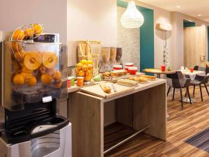 a kitchen with a counter with oranges and other foods at ibis Styles Chaumont Centre Gare in Chaumont