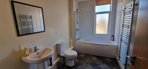 a bathroom with a sink and a toilet and a shower at SELF CHECK-IN PENTHOUSE APARTMENT in HALIFAX CENTRE in Halifax
