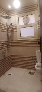 a bathroom with a shower and a toilet at جسر السويس نفرتاري in Obour +7 photos