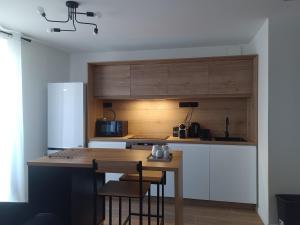 a kitchen with a wooden counter top and a refrigerator at DUPLEX 3eme étage in Le Vigan