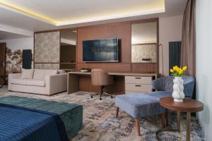 a hotel room with a bed and a desk at The Alpfine Hotel in Ankara