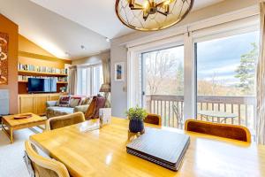 a living room with a table and a large window at Snow Creek 43 in Warren