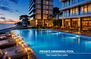 a swimming pool in front of a hotel at Miramare Magnetic Beach Hotel in Kobuleti