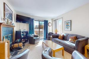 a living room with a couch and a table at Snow Mountain Village 13A in Dover