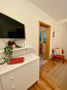 a living room with a dresser with a tv on top at Apartments Olga in Bled +23 photos