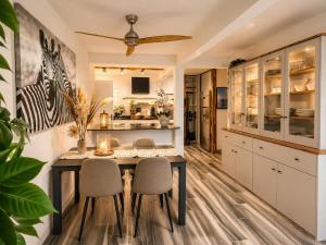 a kitchen with a dining room table and chairs at Ocean Eleven Boutique Stay - Sea View Sunset Terrace in Sainte-Anne