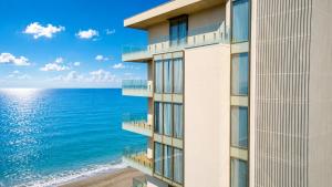 a building with a view of the ocean at Miramare Magnetic Beach Hotel in Kobuleti