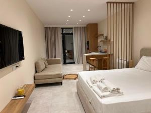 a hotel room with a bed and a living room at Piknik Suites in Dhërmi