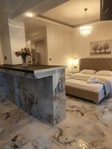 a large room with a bed and a counter with a counter sidx sidx sidx at Althea Studios & Apartments in Hanioti