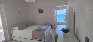 a small bedroom with a bed and a window at Villa Kapsali in Kythira