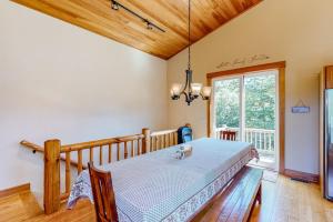 a bedroom with a bed and a large window at Butte Bliss in Ludlow