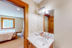 a bathroom with a sink and a bed and a mirror at Butte Bliss in Ludlow +72 photos
