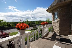 a balcony with two flower pots on a white railing at Butterfly Manor in Niagara Falls